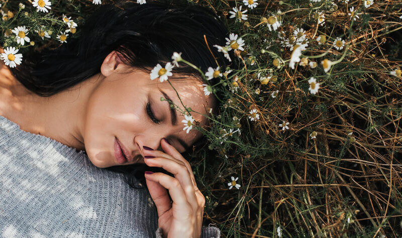 Woman laying in a bed of flowers