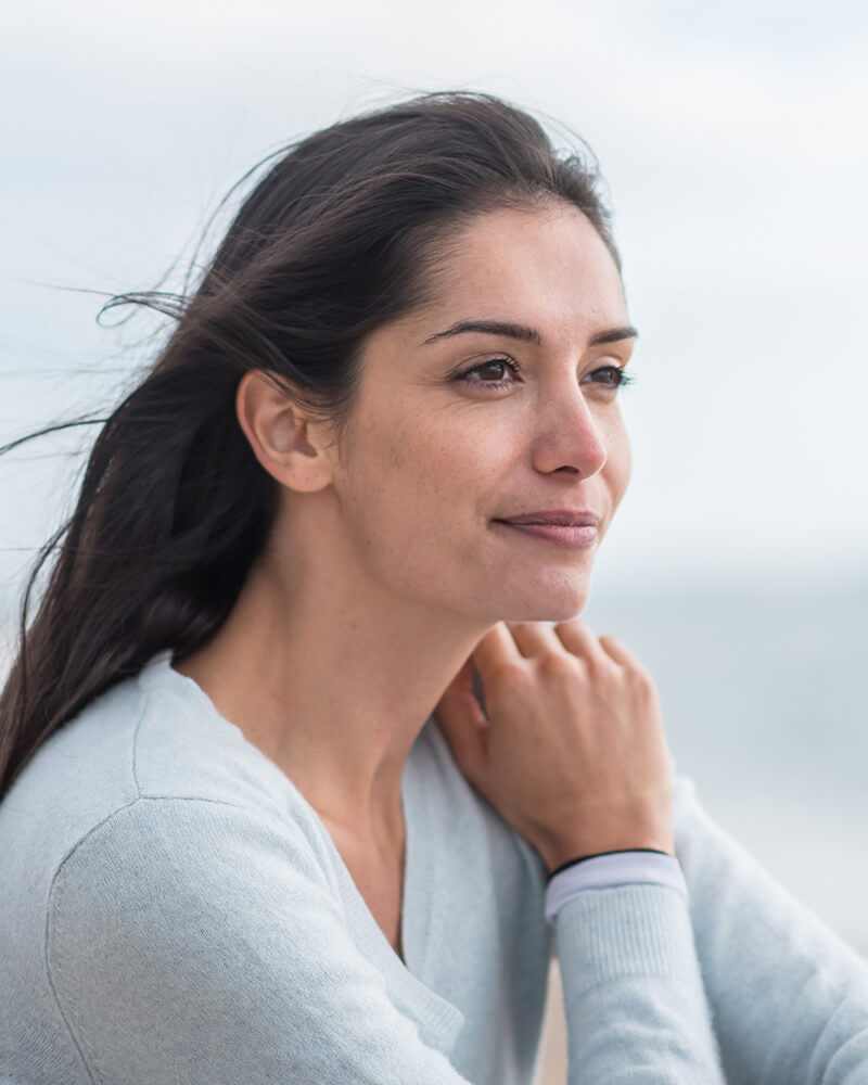 Mature woman sitting at the beach