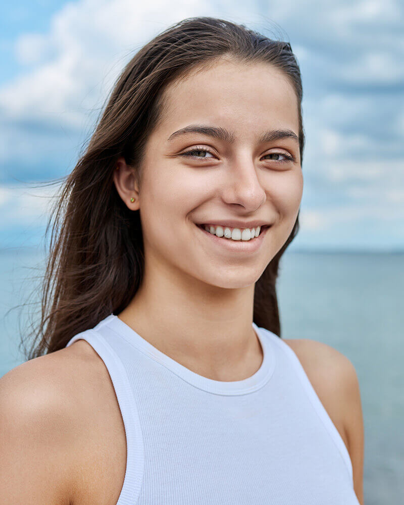Young woman in white at the beach