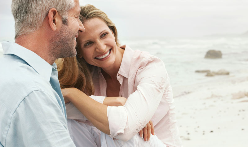 Couple laughing at the beach