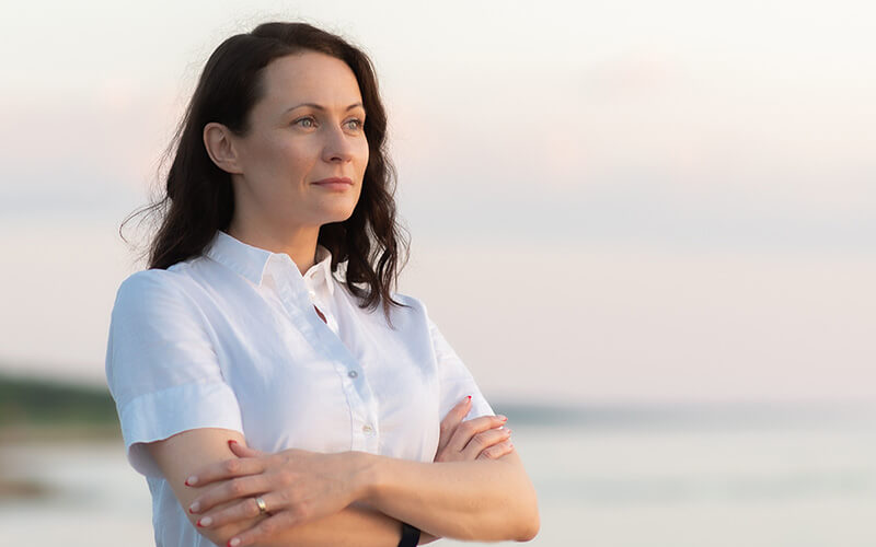 Mature woman standing at the beach