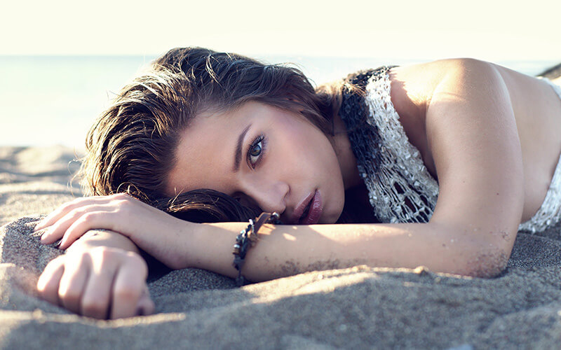 Beautiful woman laying in the sand
