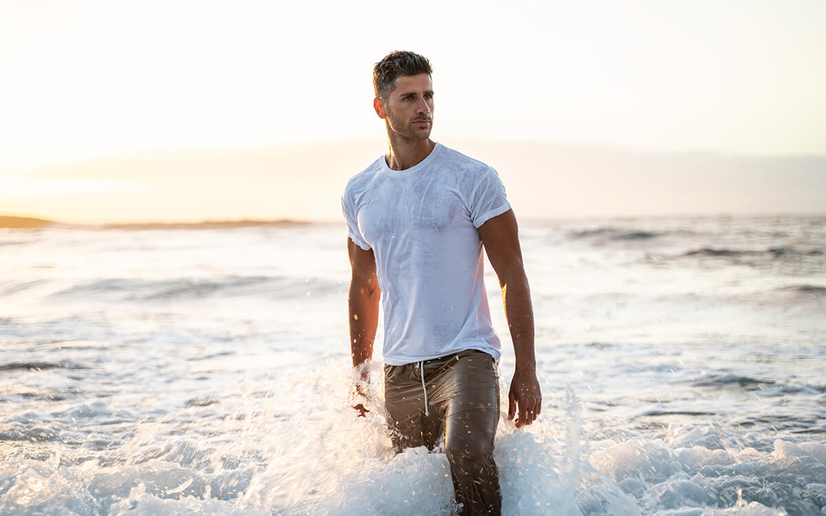 Fit man walking at the beach